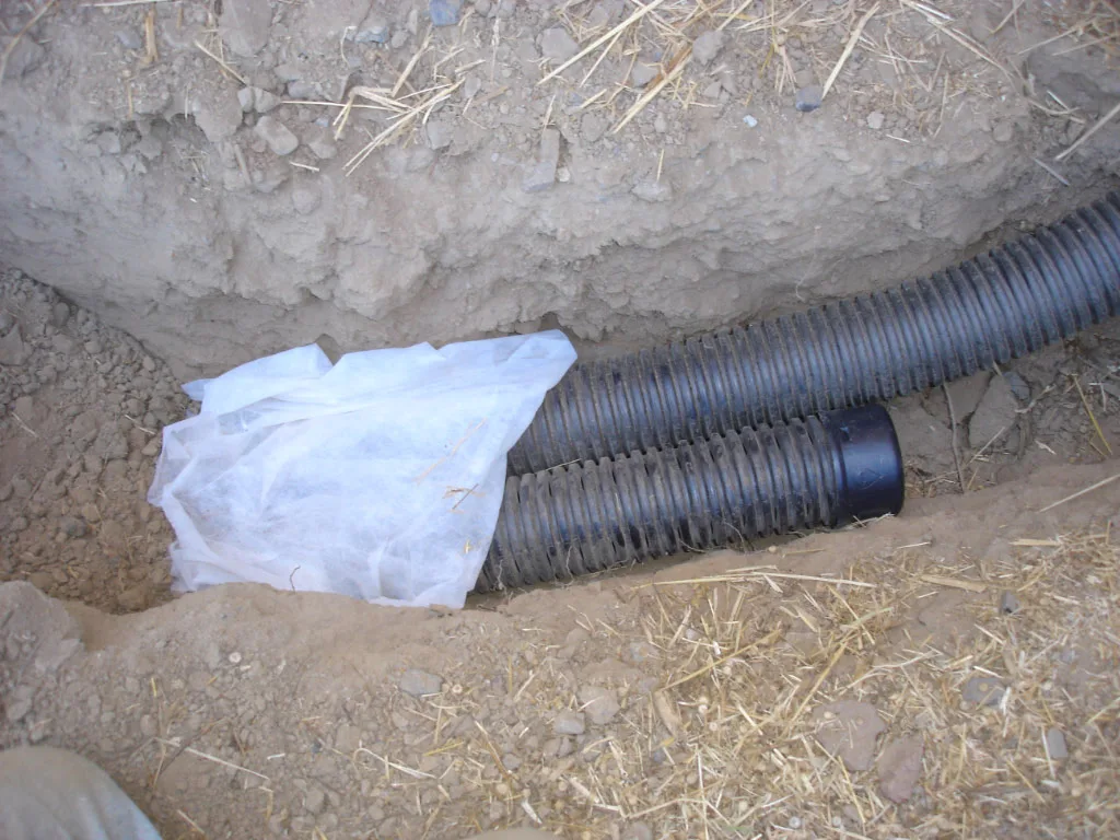 French drain trench excavation in Fort Mill SC showing red clay Piedmont subsoil